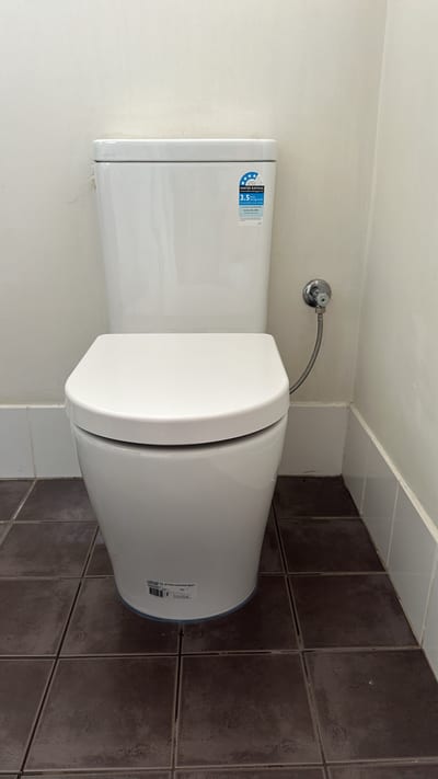 Plumber replacing a mixer tap cartridge at a bathroom basin